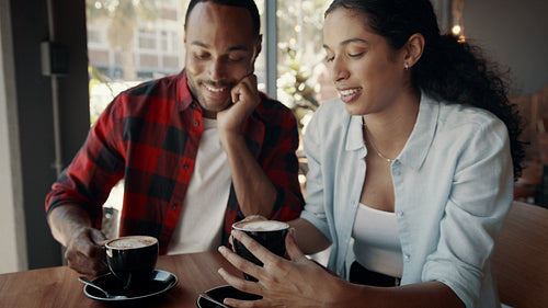 Couple enjoying drinking coffee at a coffee shop