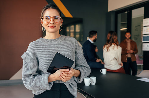 Modern businesswoman looking at the camera in a boardroom