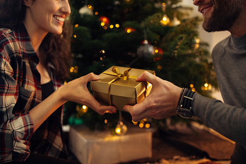 Couple celebrating Christmas together with gifts