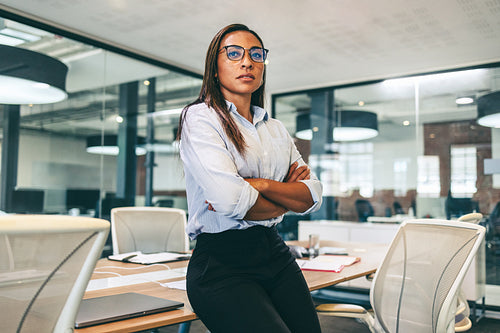 Confident businesswoman looking thoughtful in an office
