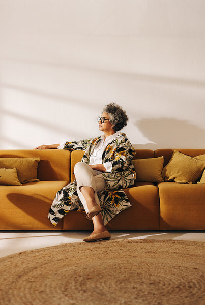 Contemplative businesswoman sitting on a couch in a lobby