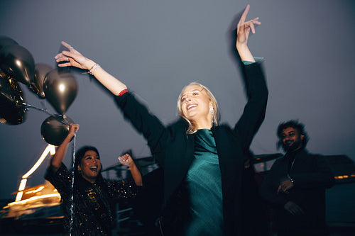 Group of friends celebrating outdoors with balloons and festive cheer