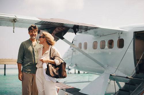 Couple standing near a seaplane ready for a travel adventure