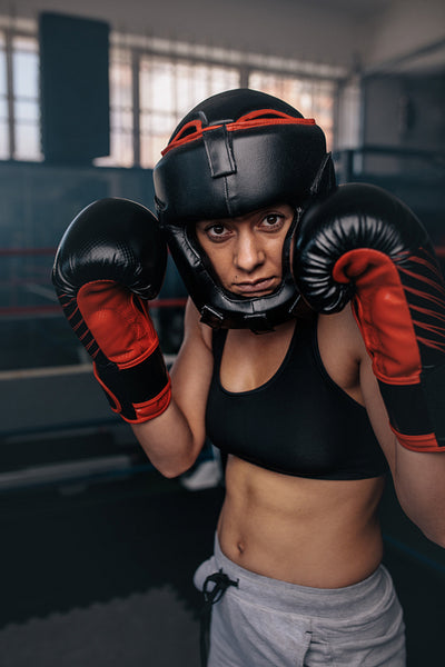 Female boxer geared up for a bout