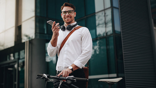 Man standing in front of office talking on mobile phone