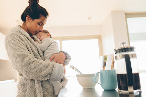 Little boy sleeping in his mother's arms