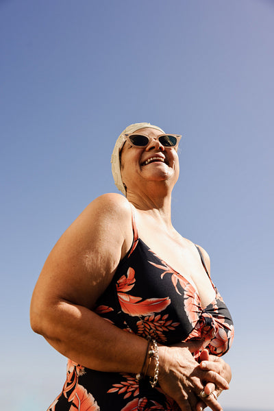 Cheerful senior woman laughing happily in swimwear