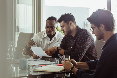 Three men working together in a business meeting