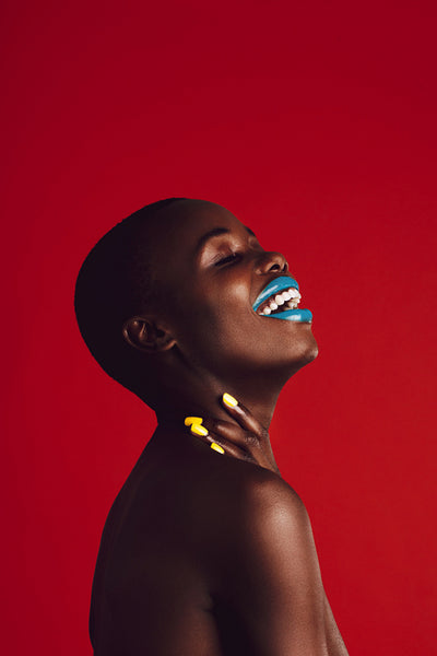 Smiling african woman with colorful makeup
