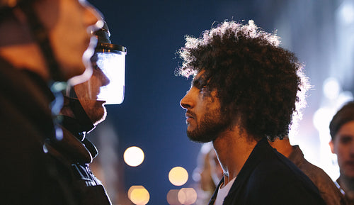 Protestors standing in front of police