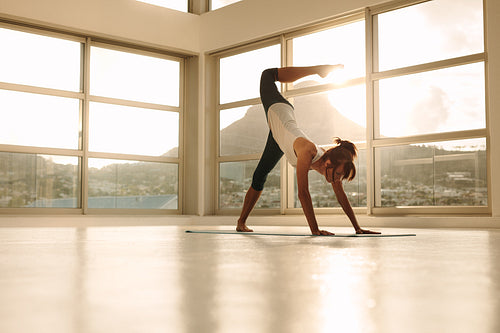 Woman exercising yoga at gym