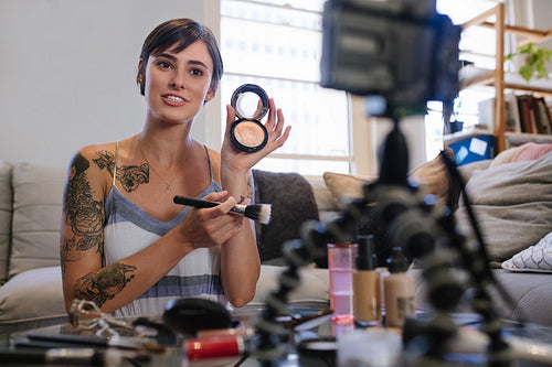 Woman vlogger reviewing beauty products