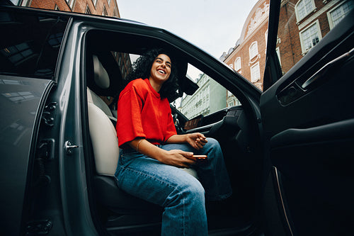 Her woman passenger moment unfolds with a phone in the car after arrival
