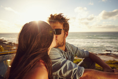 Affectionate young couple kissing at the beach