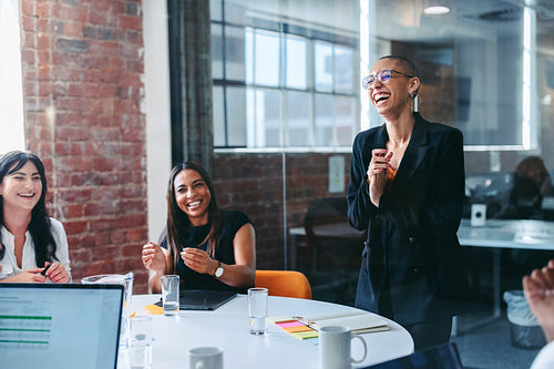 Creative businesswoman being applauded by her team