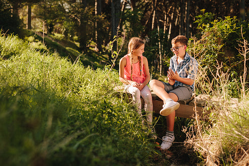 Kids in love sitting in a park and talking