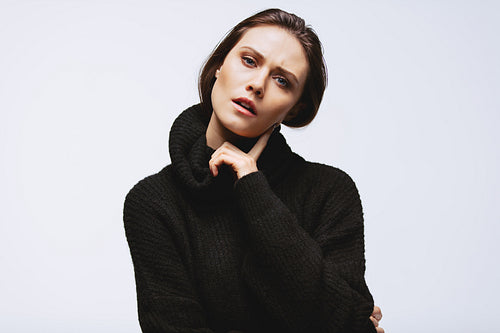 Thoughtful woman in black cardigan