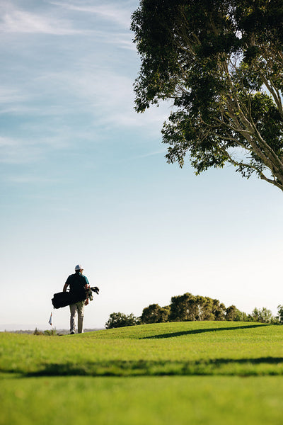 Golfer walking on a beautiful golf course on a sunny day in nature