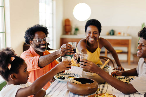Brazilian family celebrating traditional feijoada meal together