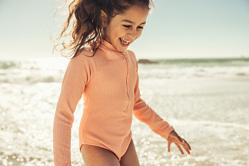 Cheerful little girl having fun in sea water