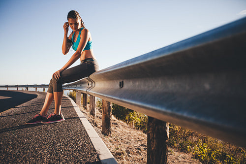 Young athlete taking break from running workout