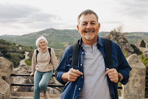 Senior man hiking with his wife outdoors