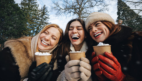 Best friend laughs with women over whipped cream drinks