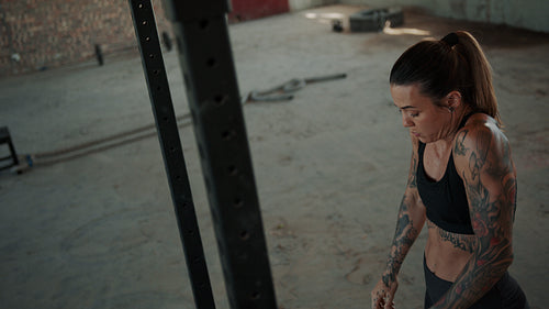 Strong woman doing pull ups workout in gym