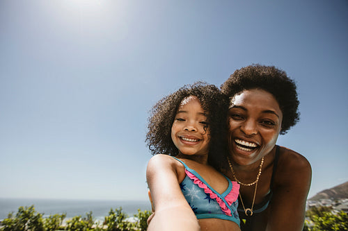 Mother and daughter taking a selfie outdoors