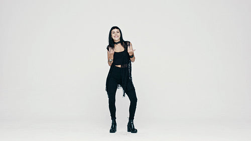 Smiling gothic woman dancing