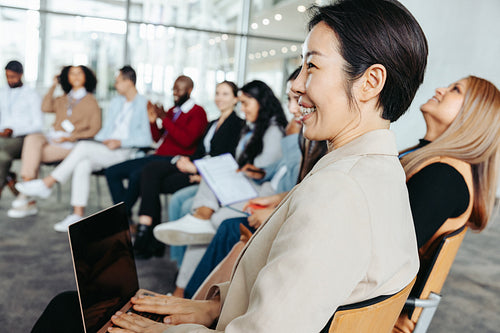Attentive businesswoman listening to a presentation in a diverse business meeting