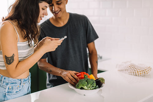 Cute couple looking at online recipes