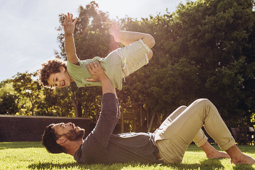 Father and son having fun playing in the park