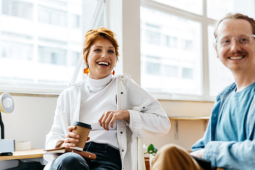 Colleagues sharing a moment in a bright co-working space
