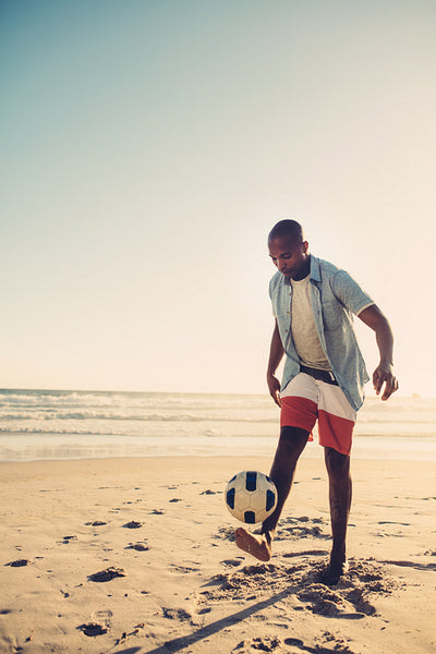African man playing with football