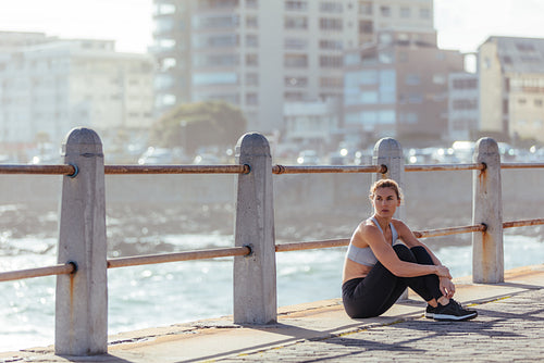 Female runner taking break after training