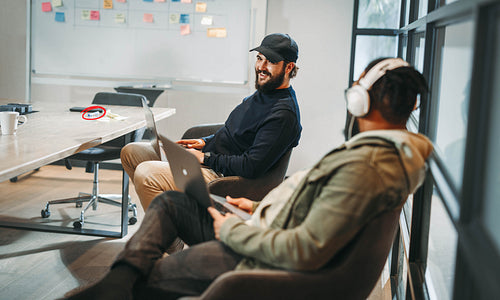 Successful collaboration: Two programmers working together in a professional office