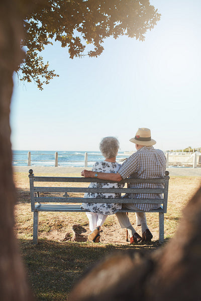 Elderly couple relaxing on a bench outdoors