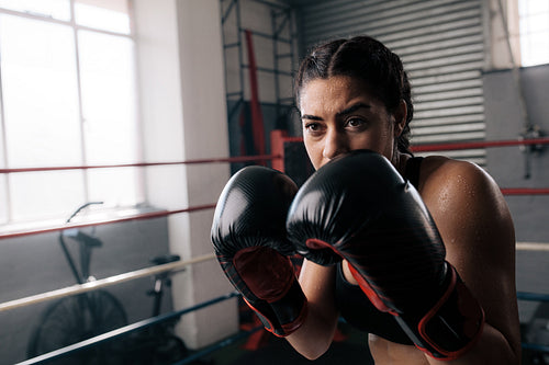 Female boxer training inside a boxing ring