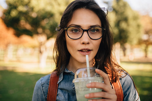 Woman at park drinking juice