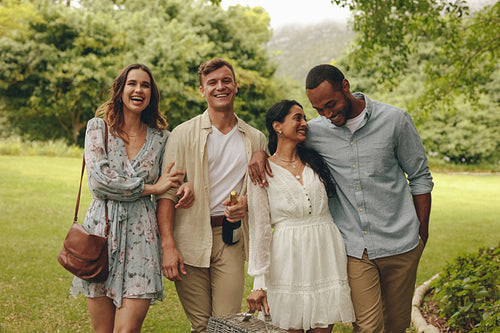 Friends going to the picnic spot in the garden