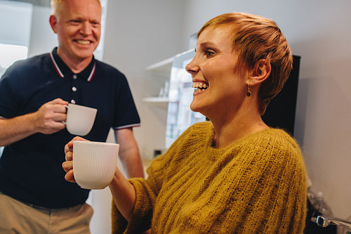 Business partners smiling during coffee break