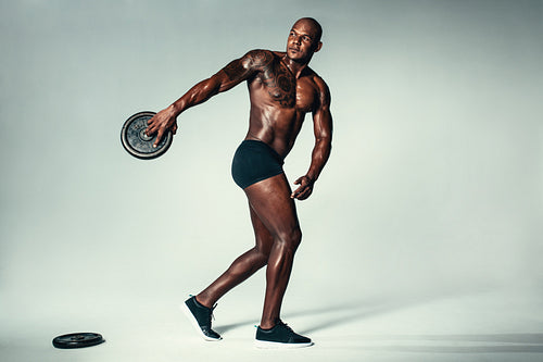 Muscular man exercising with barbell height