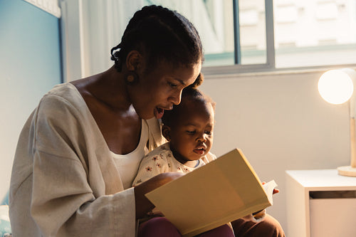 Mother reading book with child
