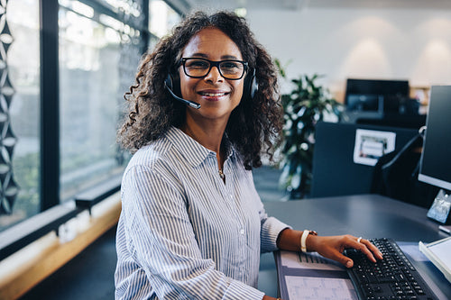 Confident female executive wearing headset