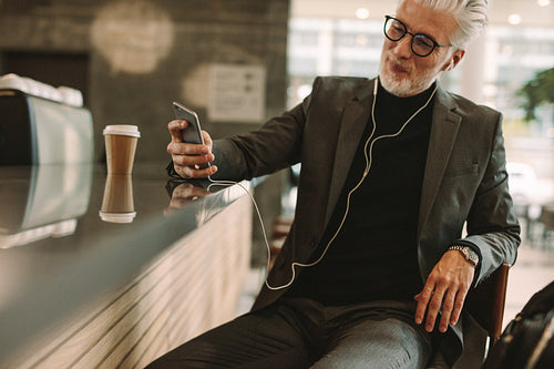 Businessman enjoying free wireless internet connection at cafe
