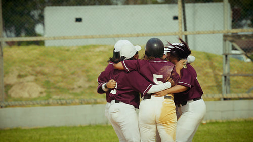 Baseball players celebrate victory in a joyful team huddle