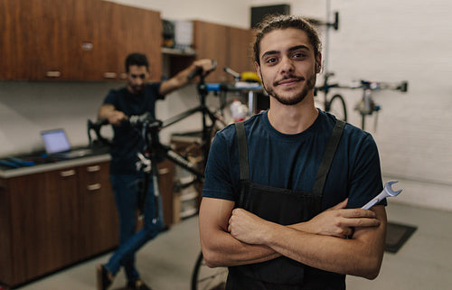 Workers repairing bicycles in workshop