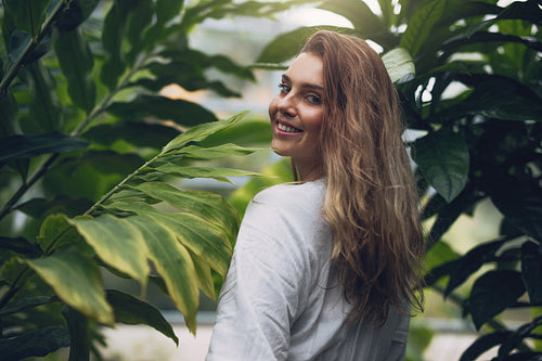 Attractive young woman in greenhouse
