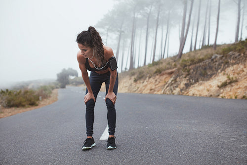 Young woman taking a break during the workout.